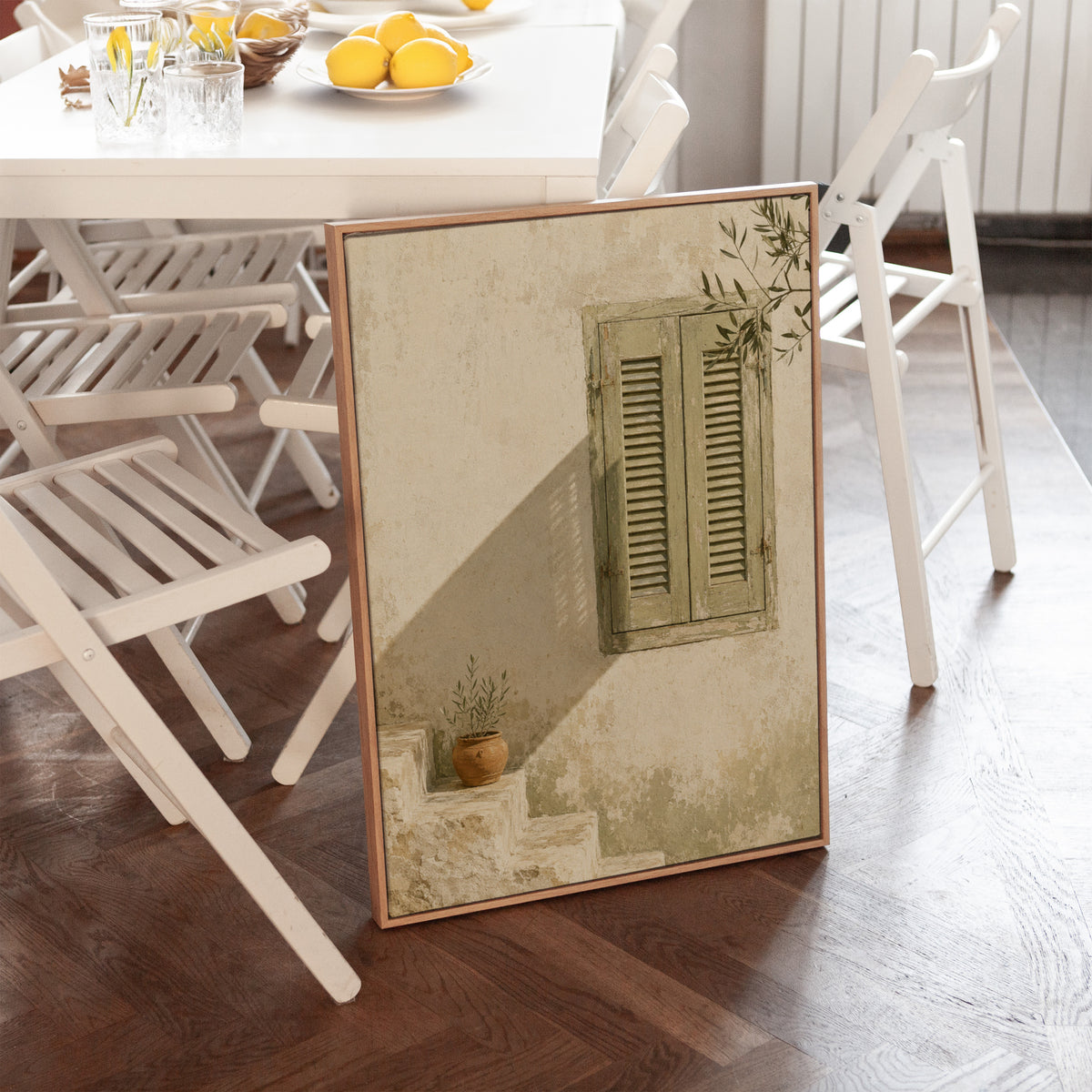 Sage green louvred shutters on a bone wall with an olive branch above, canvas print