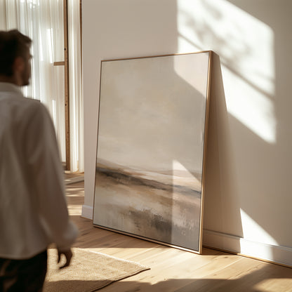 Brown canvas wall art showing abstract neutral landscape with a pale sky and layered bands of brown and cream