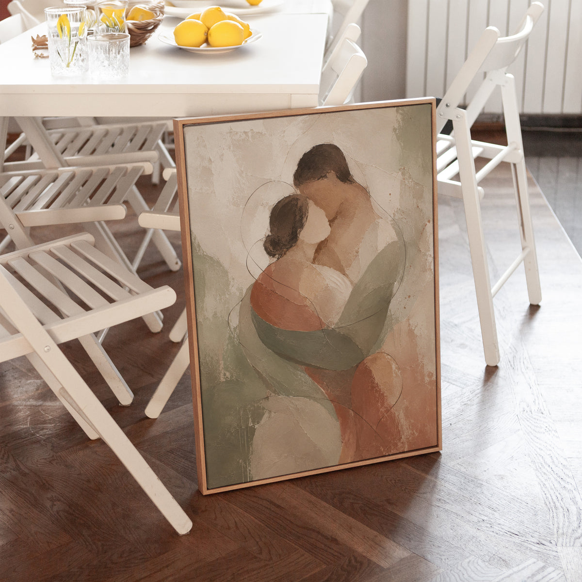 Figurative canvas wall art showing abstract embracing couple in sage green and rust on a pale ground