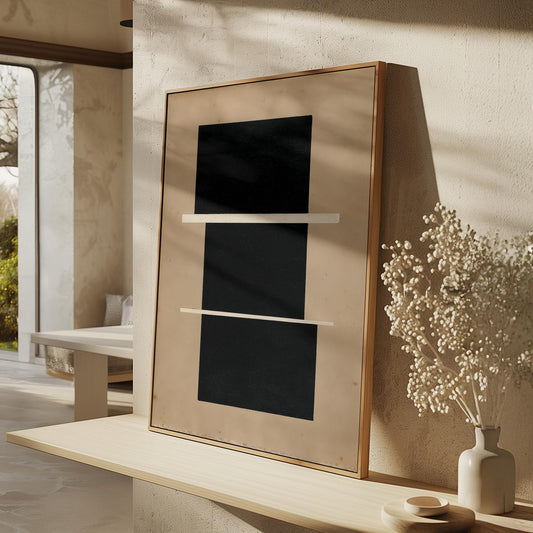 a minimalist interior design with a large black square frame on a beige wall, a white vase with white flowers, and a wooden shelf with a white table.