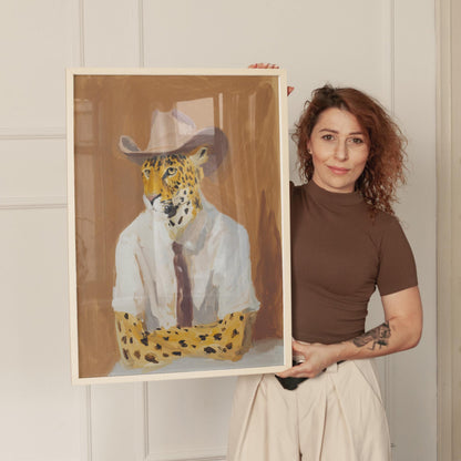 Framed painting of a leopard wearing a white shirt and a cowboy hat