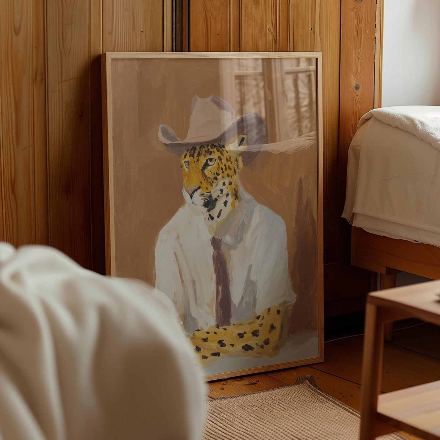 a framed painting of a leopard wearing a cowboy hat, sitting in a room with wooden walls.