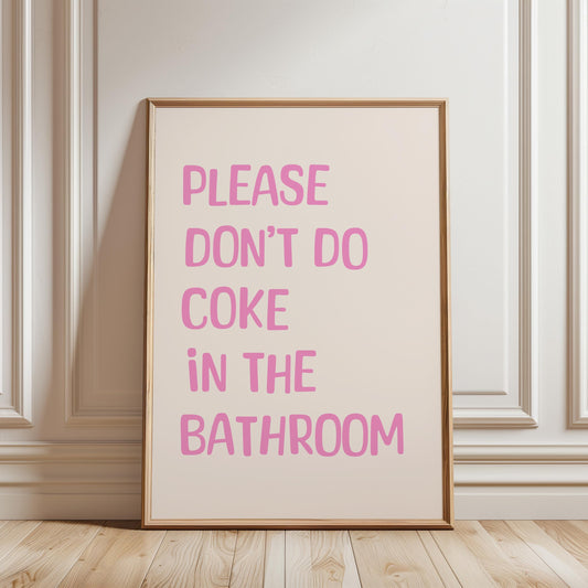 A framed poster with the text "PLEASE DON'T DO COCO IN THE BATHROOM" in pink letters.