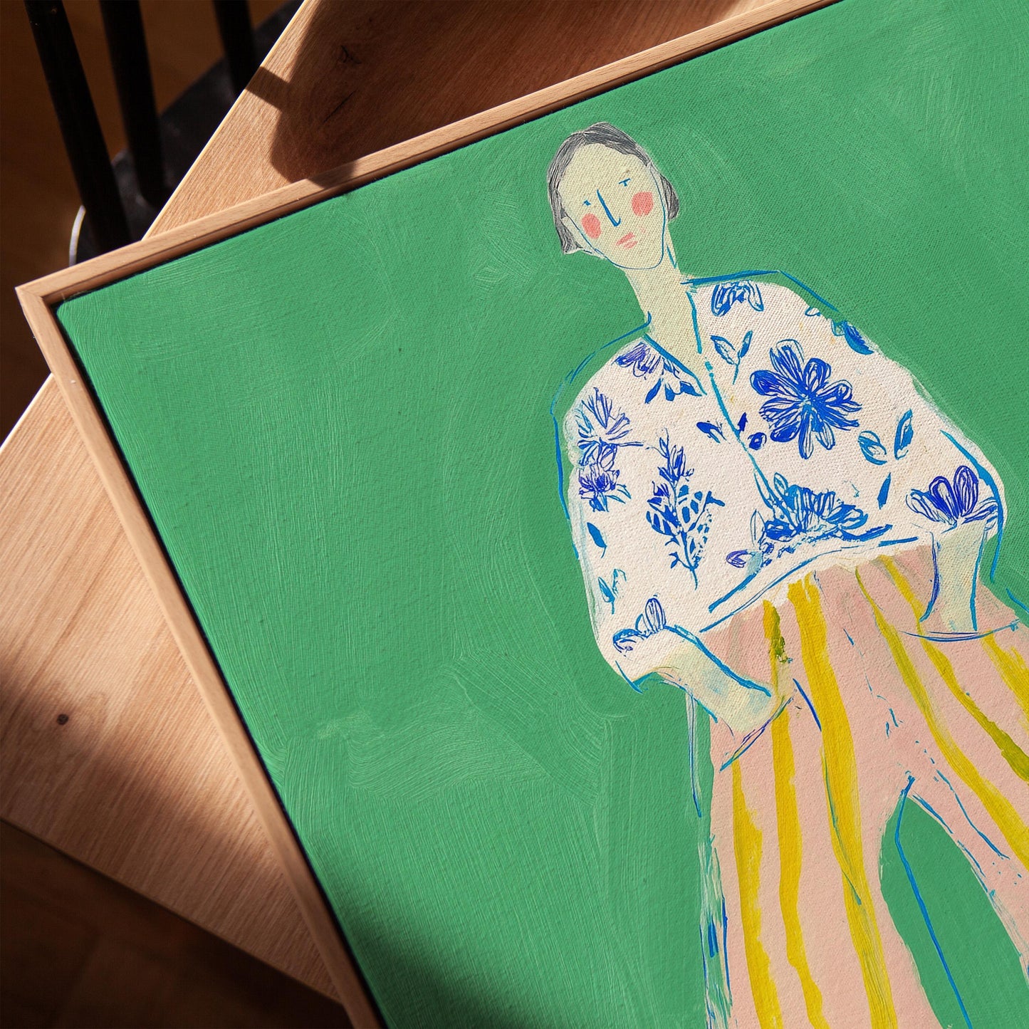Figurative Woman Canvas Wall Art Green Background with Striped Pants and Floral Blouse Frame
