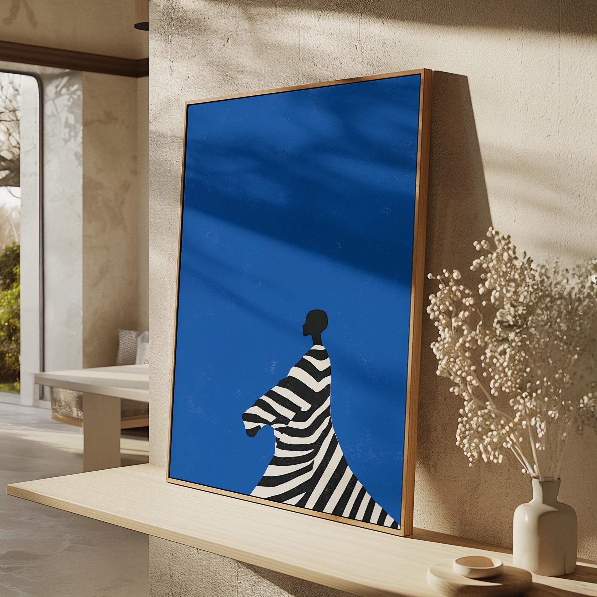 Figurative Canvas Wall Art Woman in Black and White Striped Dress on Bold Blue Background Framed Print