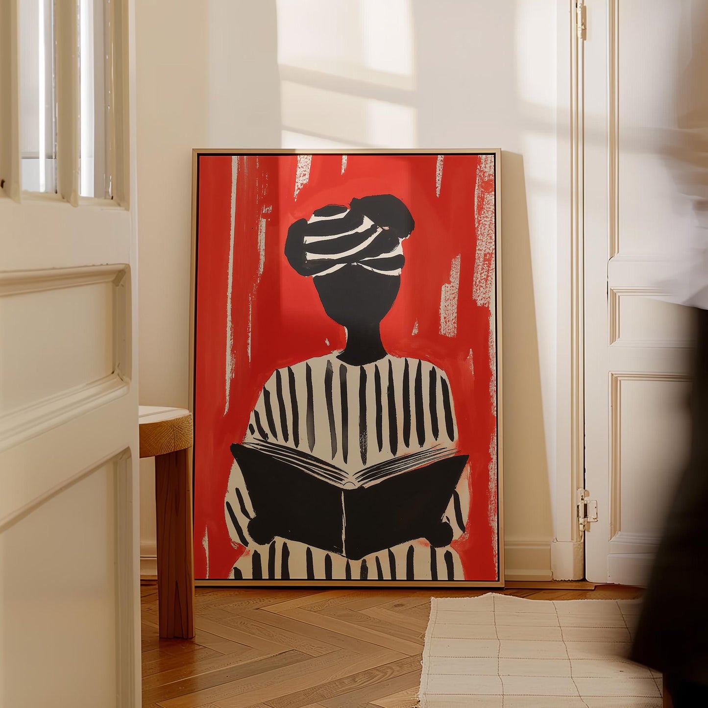Figurative Canvas Wall Art Woman Reading in Black and White Striped Outfit on Red Background Frame