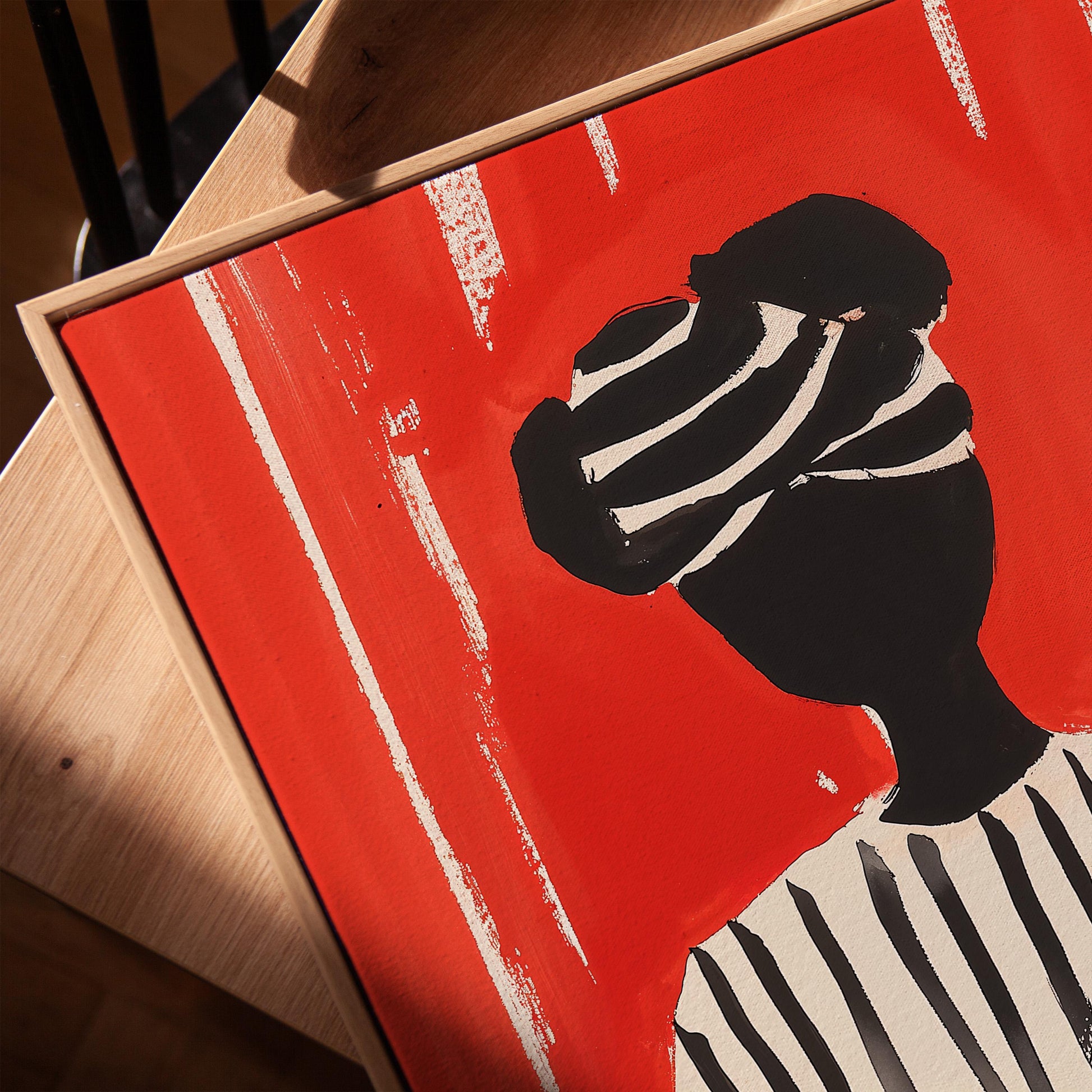Figurative Canvas Wall Art Woman Reading in Black and White Striped Outfit on Red Background Frame