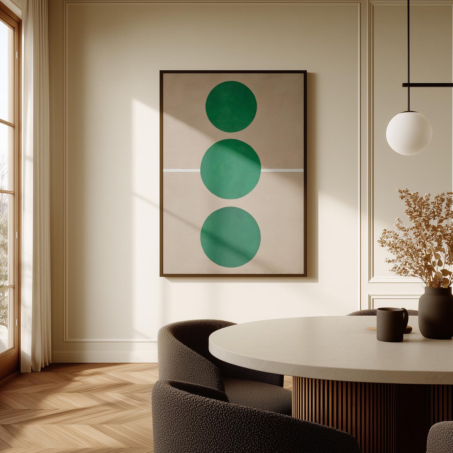 a modern dining room with a round table, a black chair, and a framed abstract artwork with three green circles on the wall.