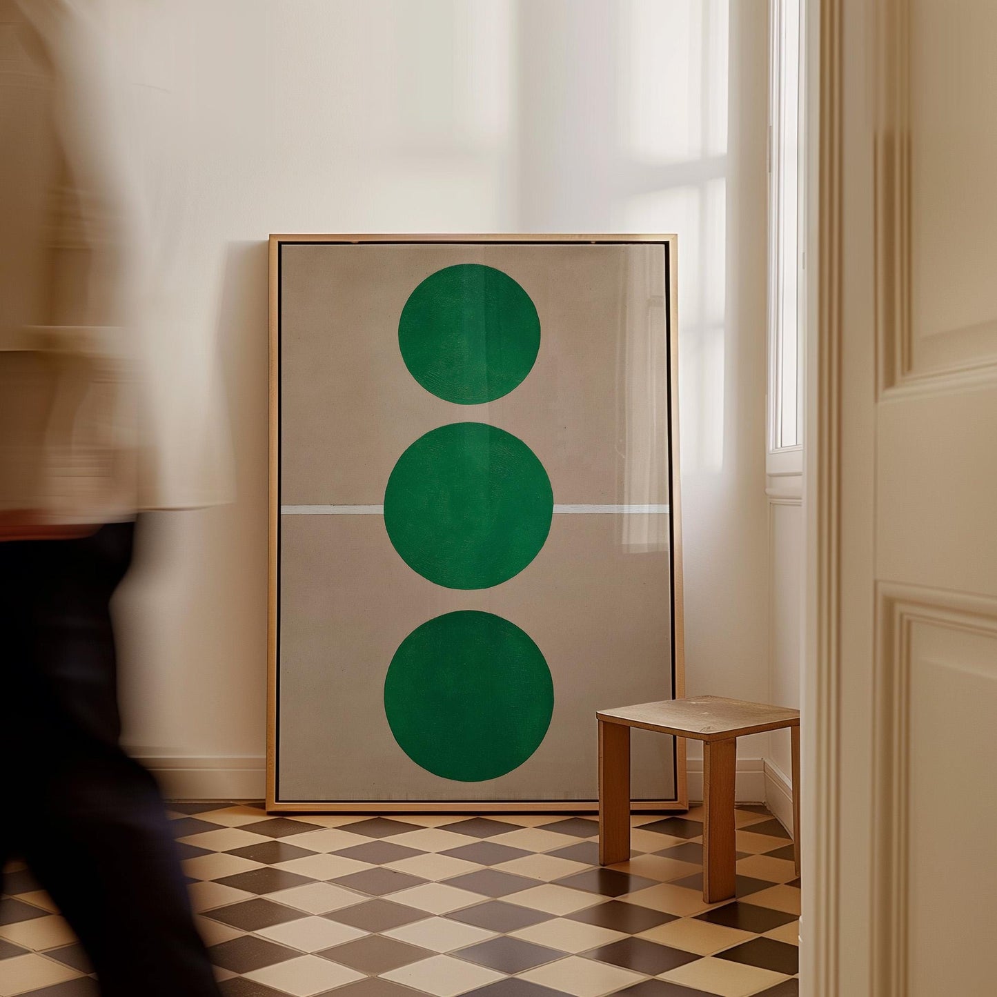 a large framed artwork with three green circles on a checkered floor, and a small wooden stool in the corner of the room.