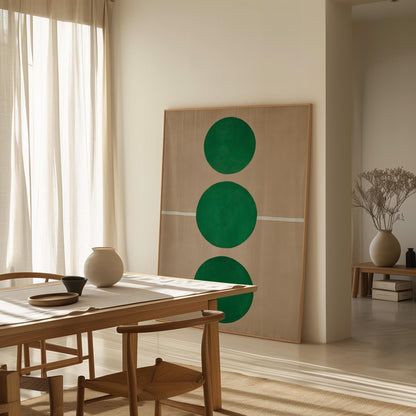 a minimalist dining room with a wooden table and chairs, a large abstract painting featuring three green circles on the wall, and a vase of dried flowers on a side table.