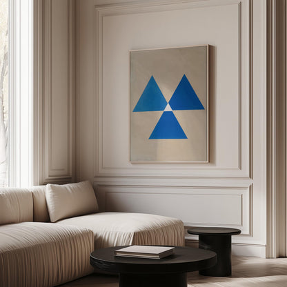 a modern living room with a large window, a white sofa, and a framed abstract artwork featuring blue triangles on the wall.