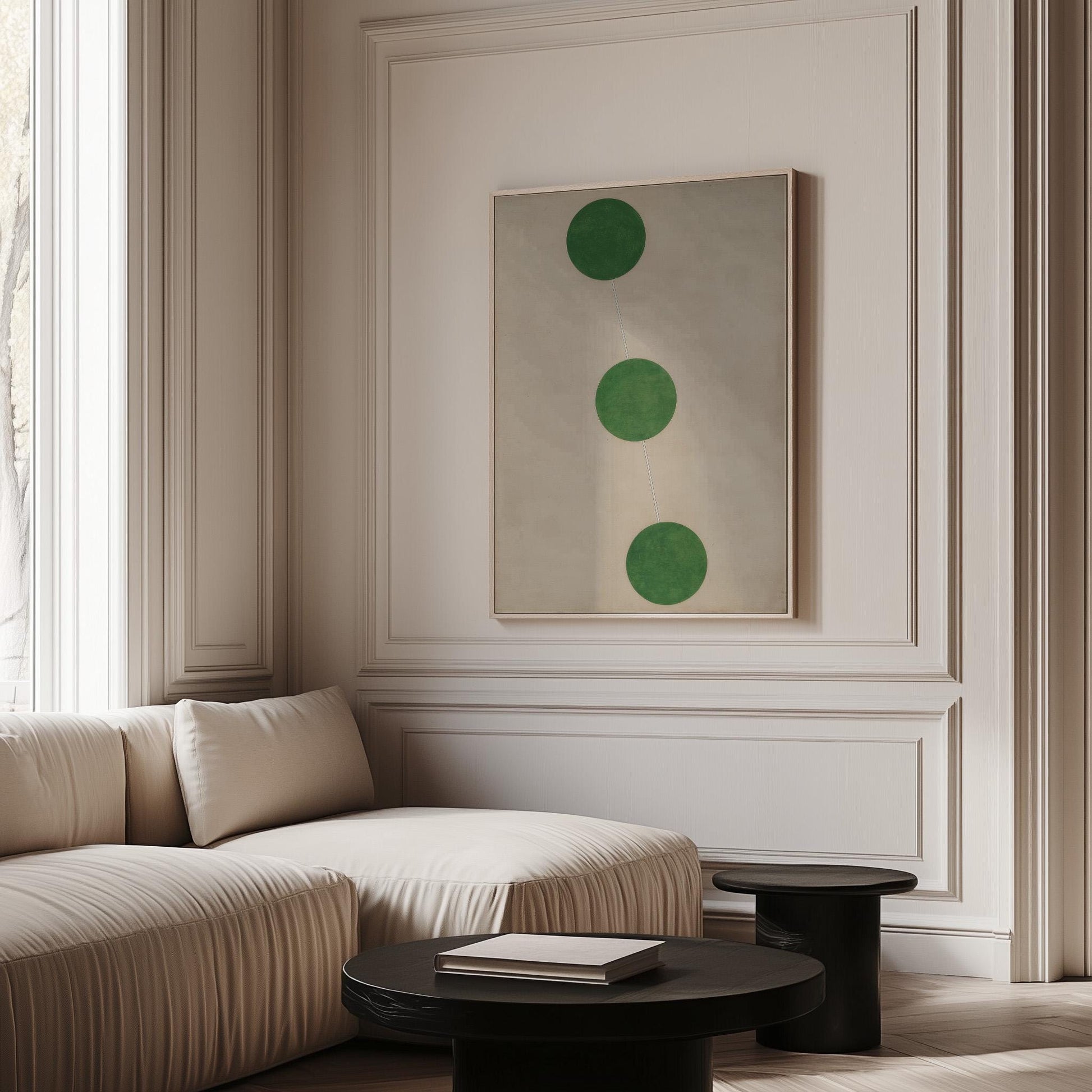 a modern living room with a white sofa, a black coffee table, and a framed artwork featuring three green circles on the wall.