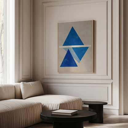 a modern living room with a large abstract painting featuring blue triangles on the wall. The room has a white sofa and a black coffee table, creating a minimalist and elegant atmosphere.