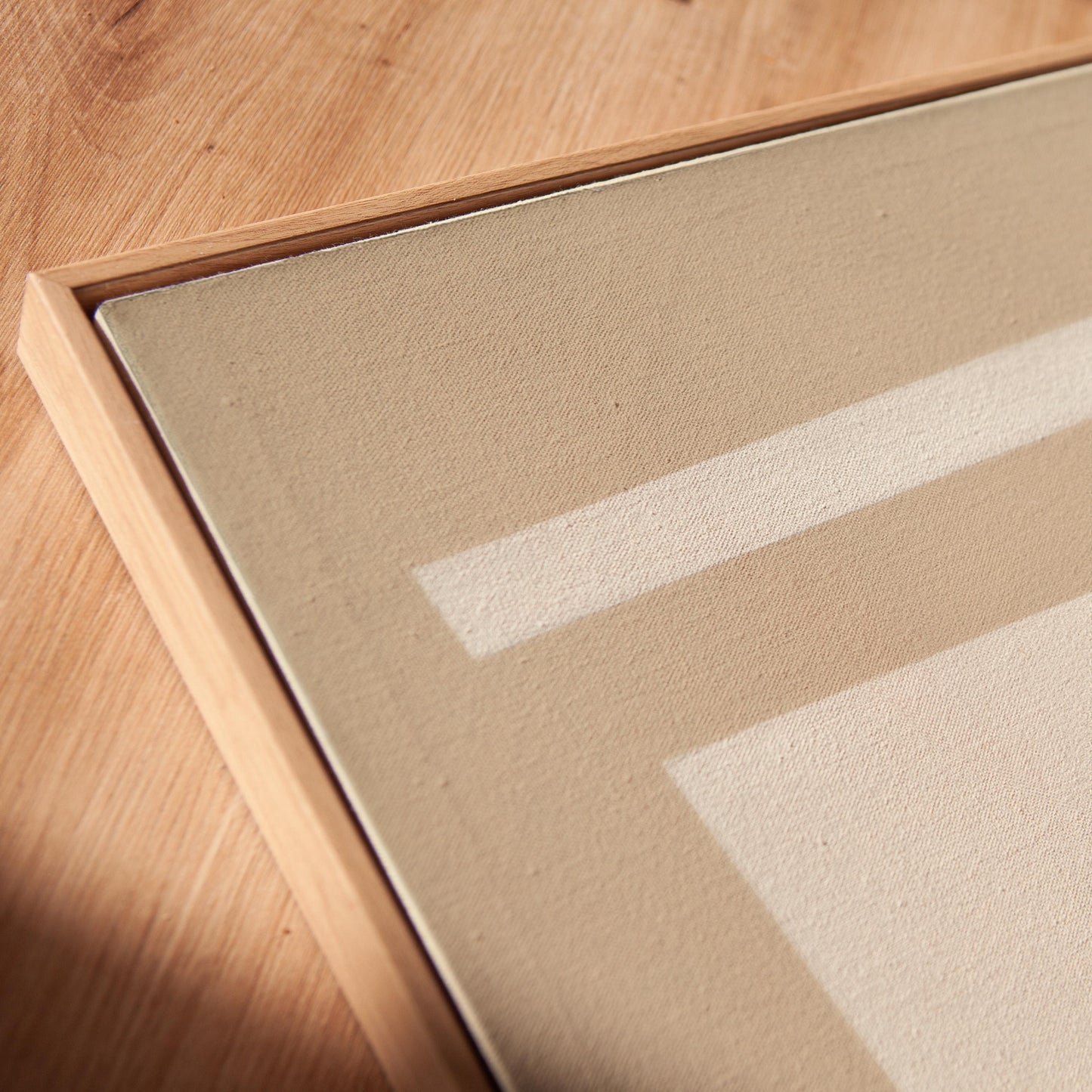 a close-up view of a wooden surface with a beige-colored frame, and a white line running across it.