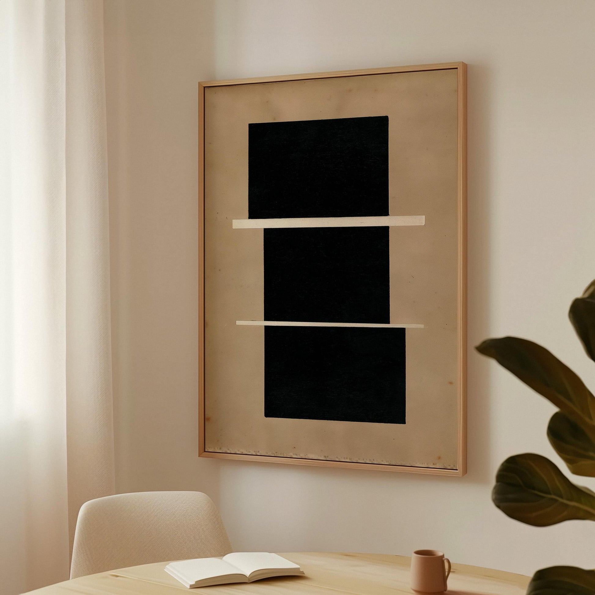 a minimalist interior design with a large black square artwork hanging on a white wall above a wooden table. The table has a book and a mug on it, suggesting a cozy reading or relaxing space.