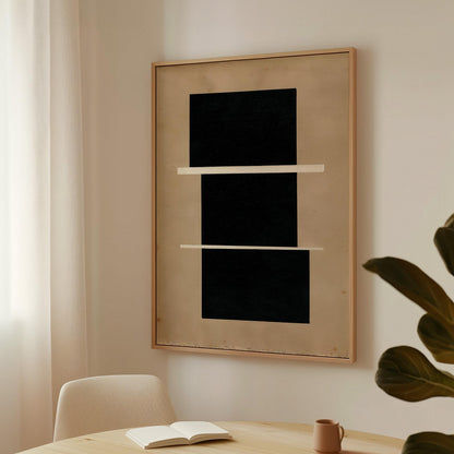 a minimalist interior design with a large black square artwork hanging on a white wall above a wooden table. The table has a book and a mug on it, suggesting a cozy reading or relaxing space.