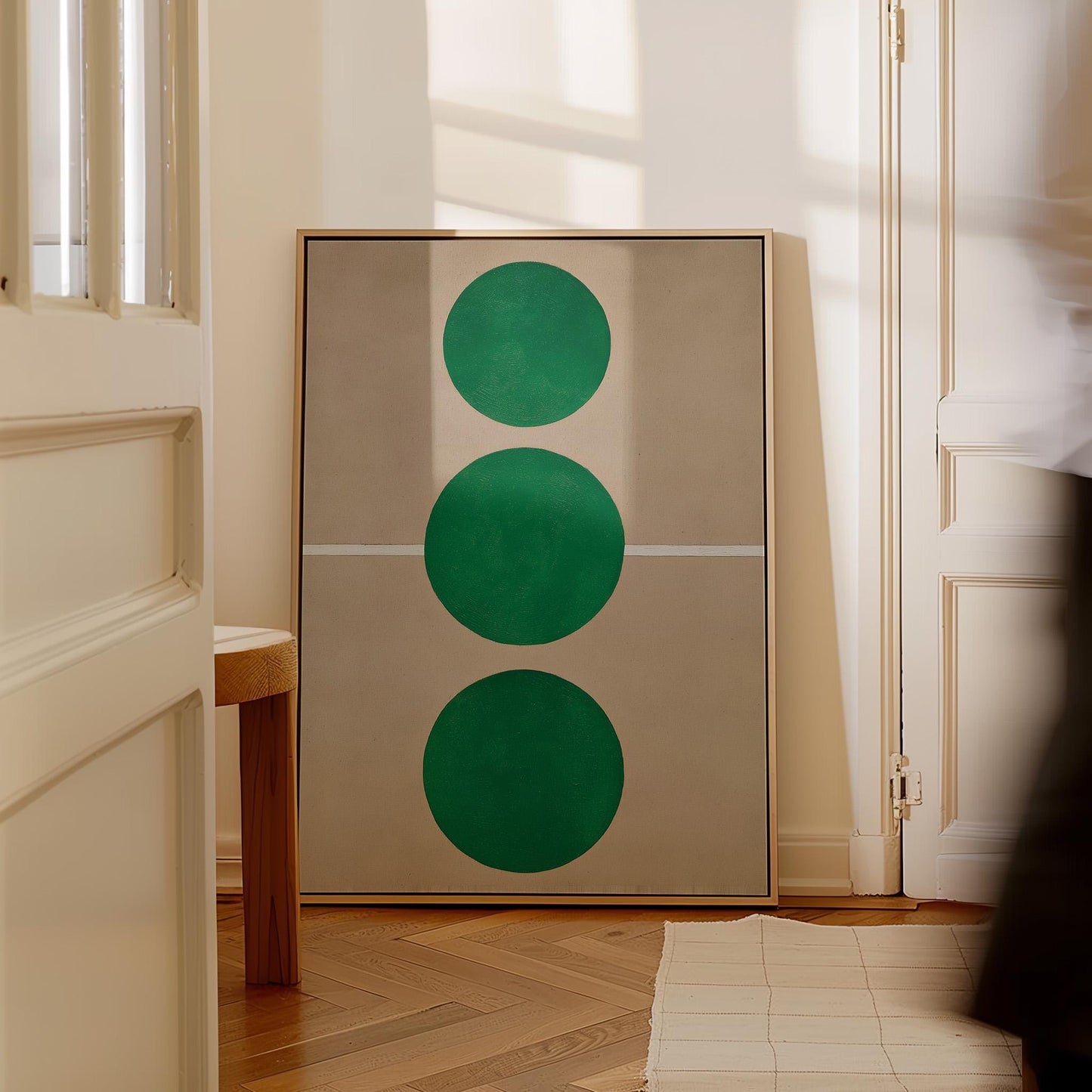 a large abstract painting with three green circles on a beige background.