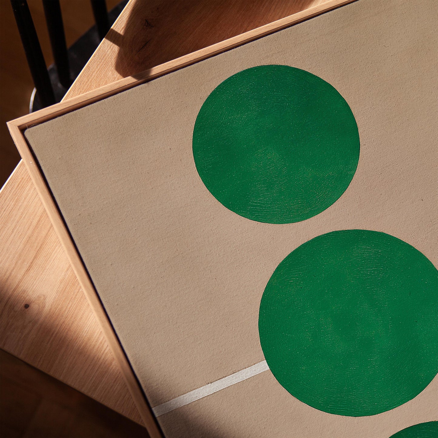 two green circles on a beige background.