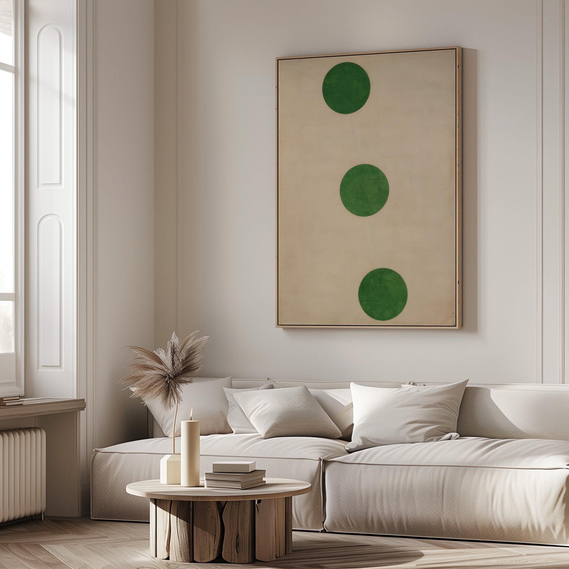 a modern living room with a white sofa, a round wooden coffee table, and a large abstract painting featuring three green circles on the wall.