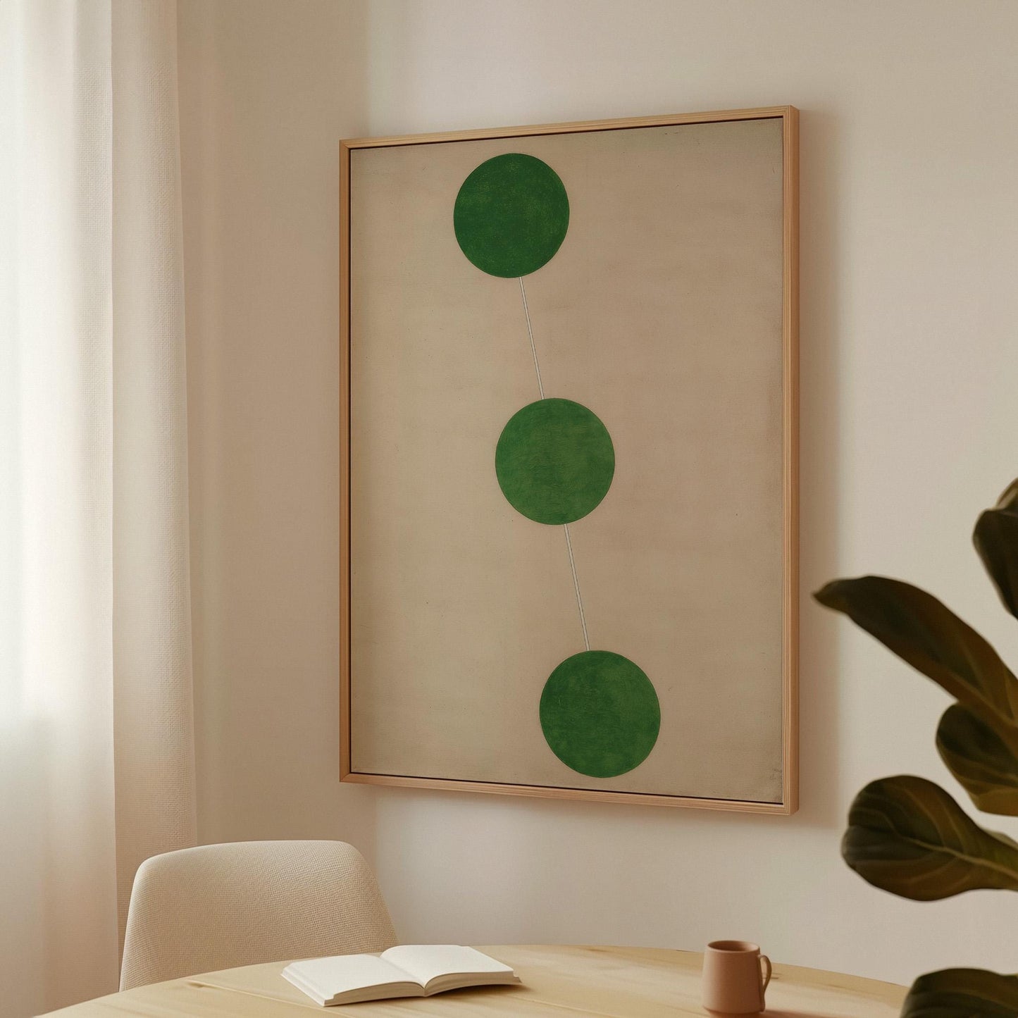 a minimalist interior design with a large framed artwork hanging on the wall, a white chair, and a small table with a book and a coffee cup on it.