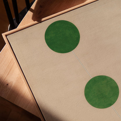 two green circles on a beige background.