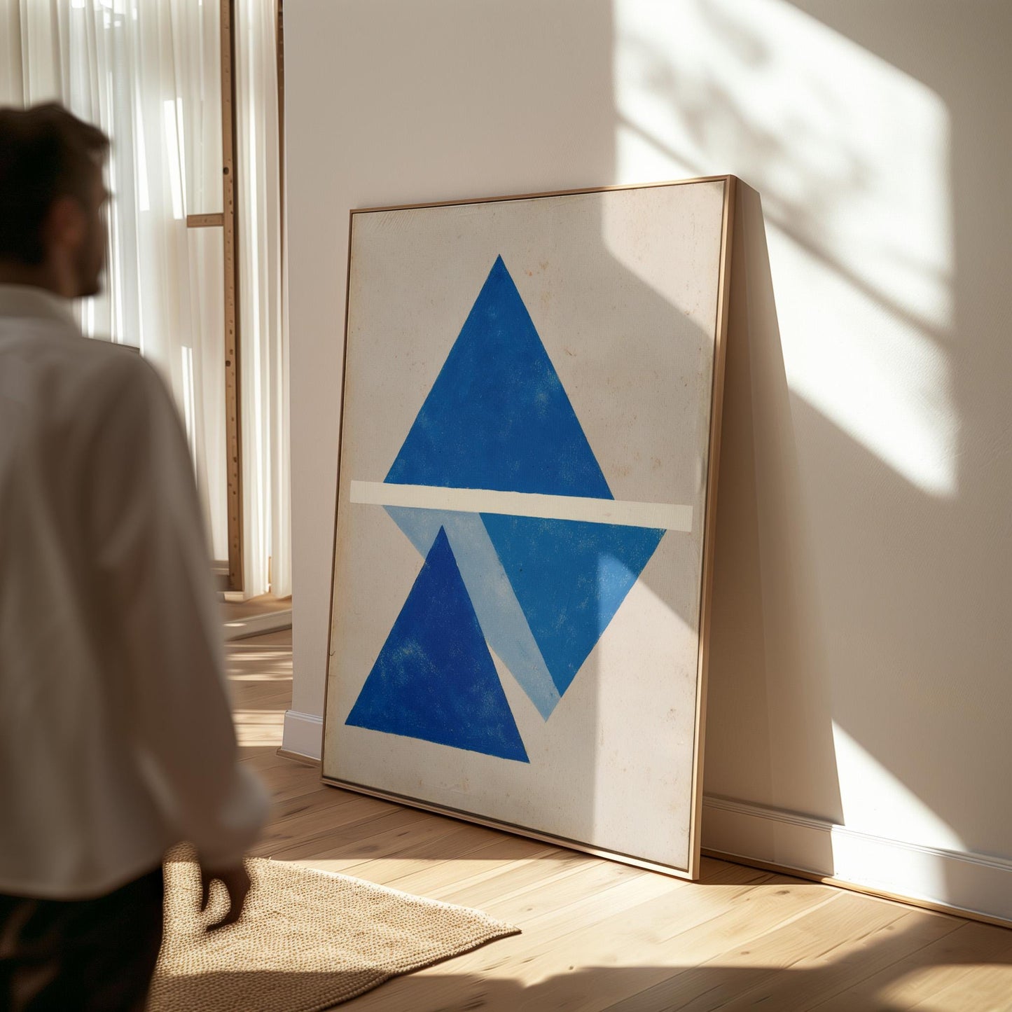a large blue triangle on a white background, with a person standing in the background.