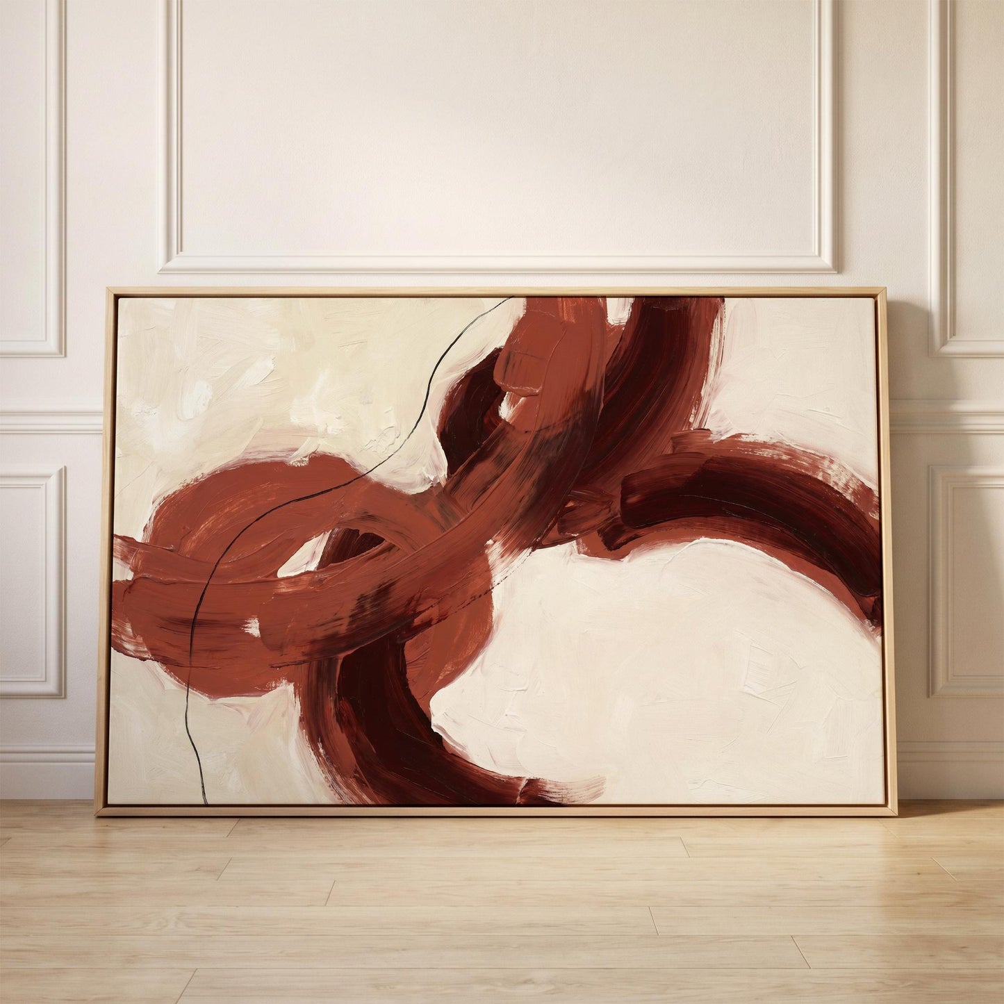 a large abstract painting with bold red and brown brushstrokes, displayed on a wooden floor against a white wall.