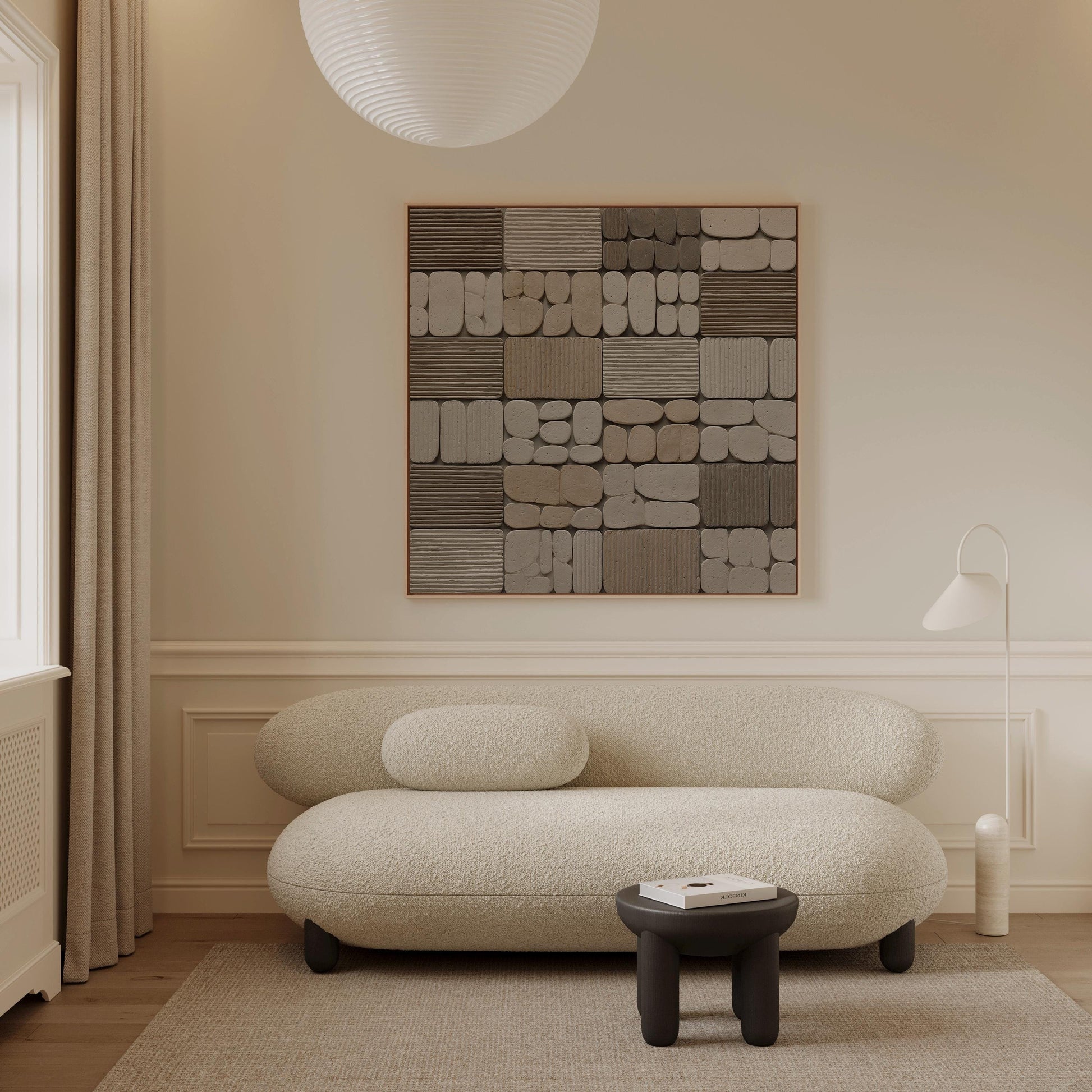 a modern living room with a large abstract painting on the wall, a white sofa, and a small black stool.
