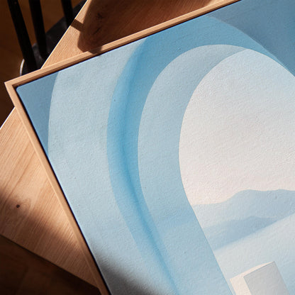 a close-up view of a blue abstract painting with a curved line design.