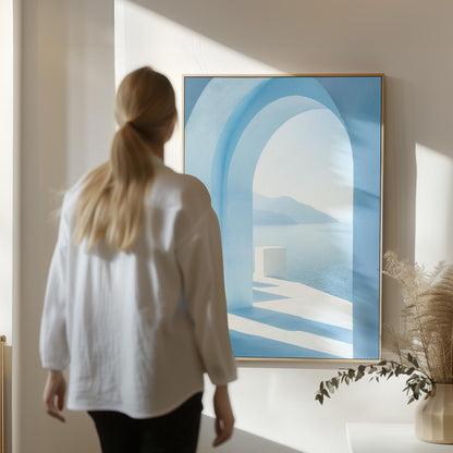 A woman in a white shirt stands in front of a large blue painting depicting an arched doorway leading to a serene landscape.