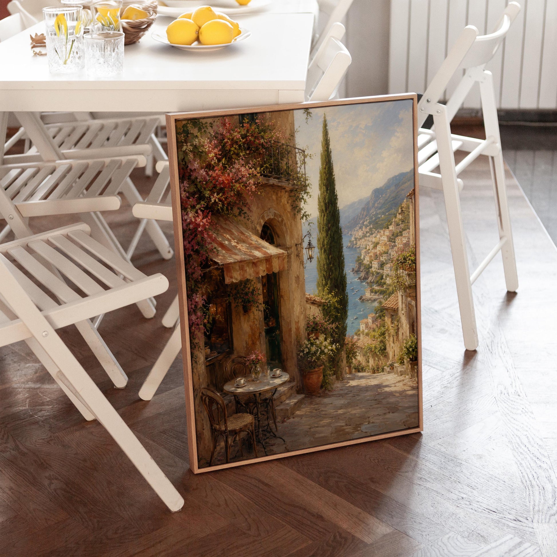 Italian village cafe painting with striped awning and coastal view, canvas wall art on a quiet wall in a considered interior