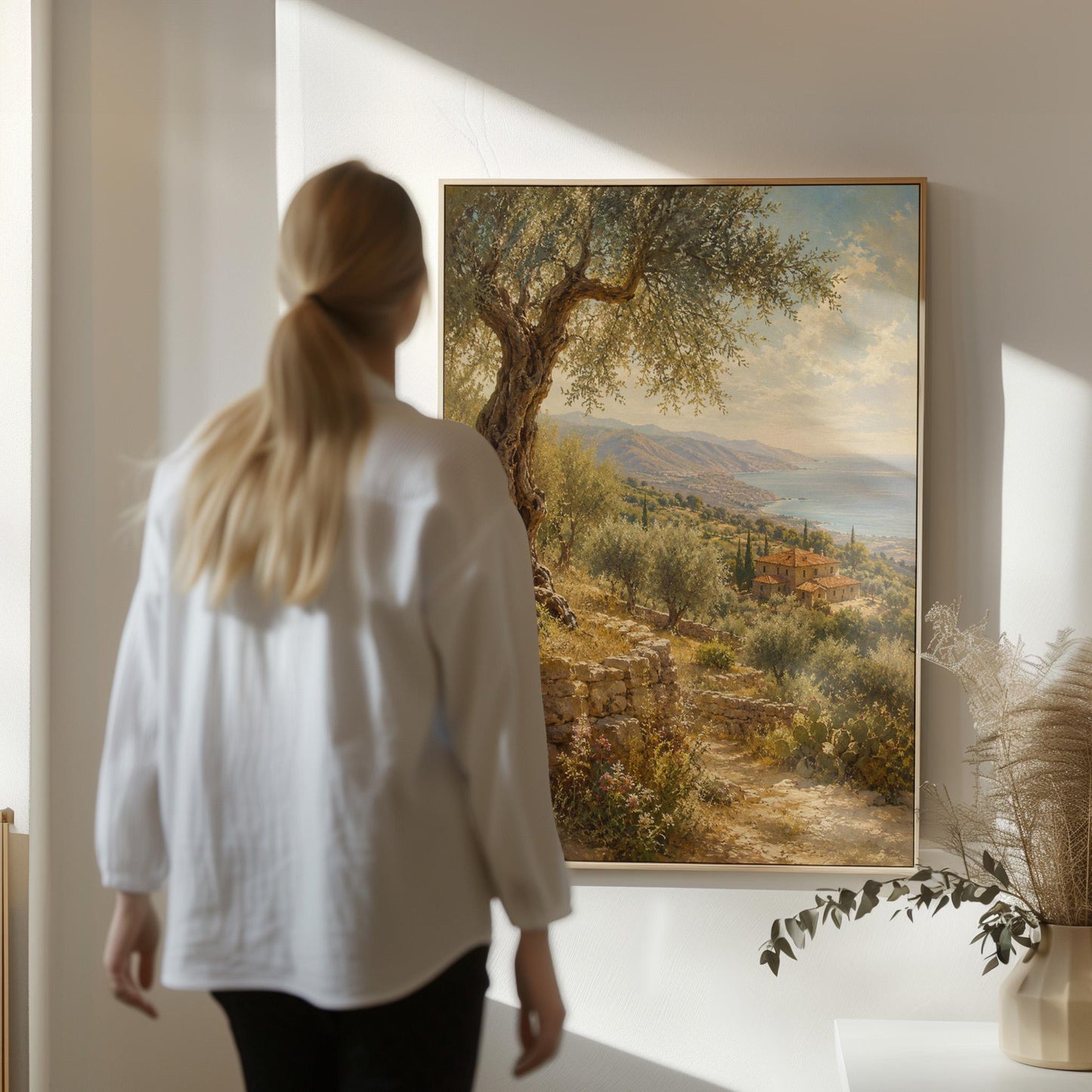 Old olive tree over a Mediterranean coastline, canvas wall art styled against a soft white wall