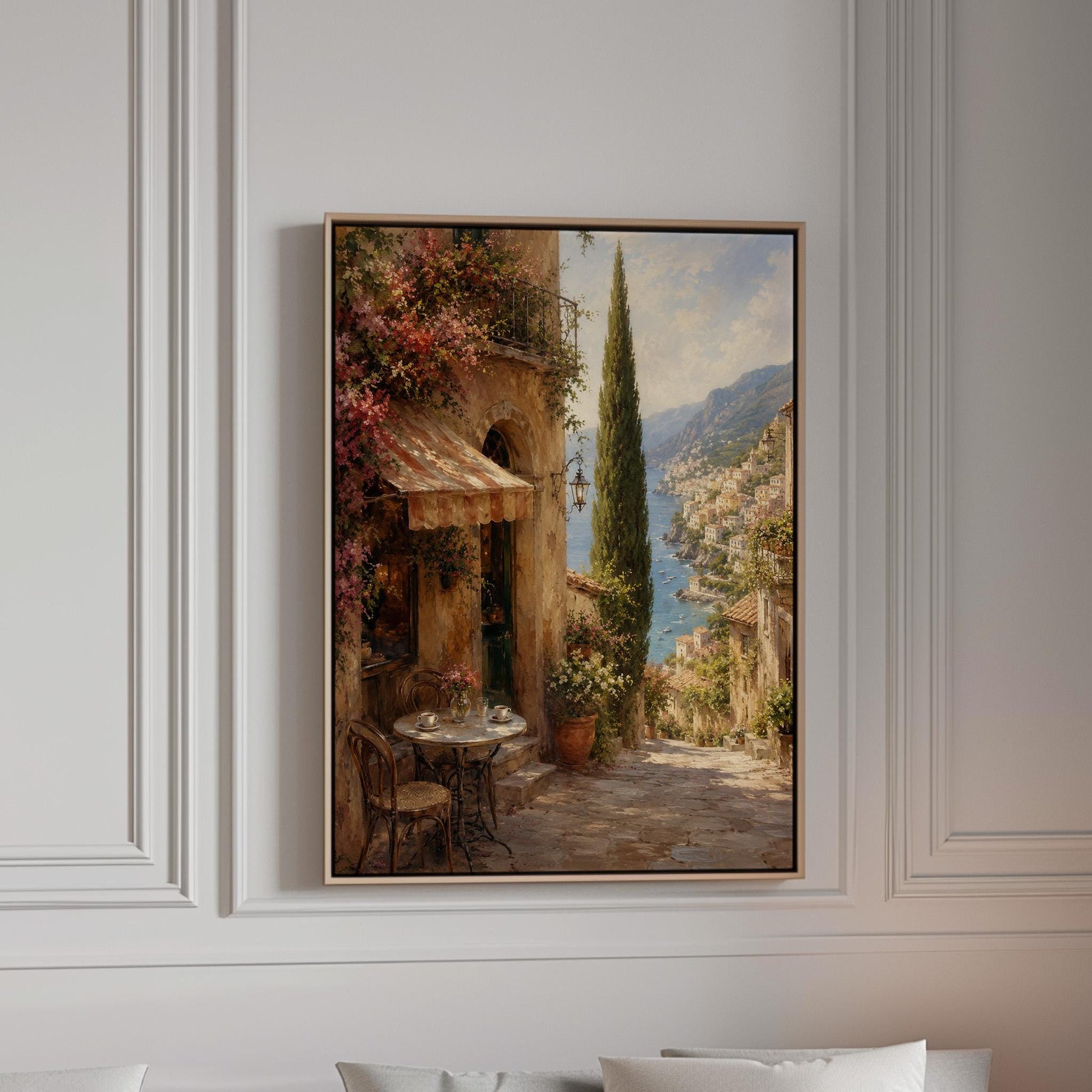 Italian village cafe painting with striped awning and coastal view, canvas print in a bright room with natural daylight