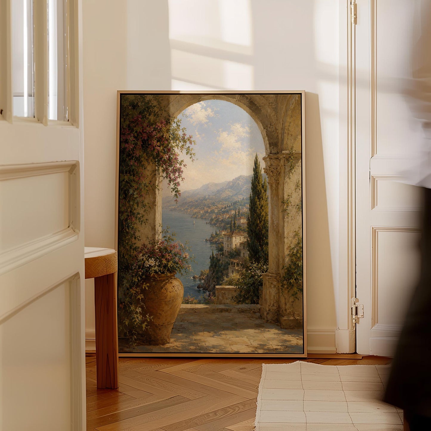 Mediterranean coastline seen through an old stone arch, canvas print styled against a soft white wall