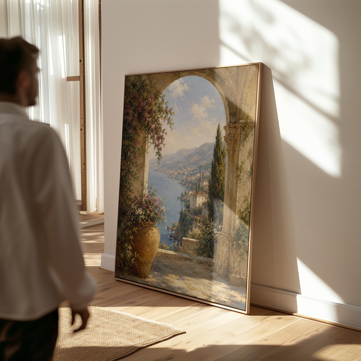 Mediterranean coastline seen through an old stone arch, canvas wall art styled against a soft white wall