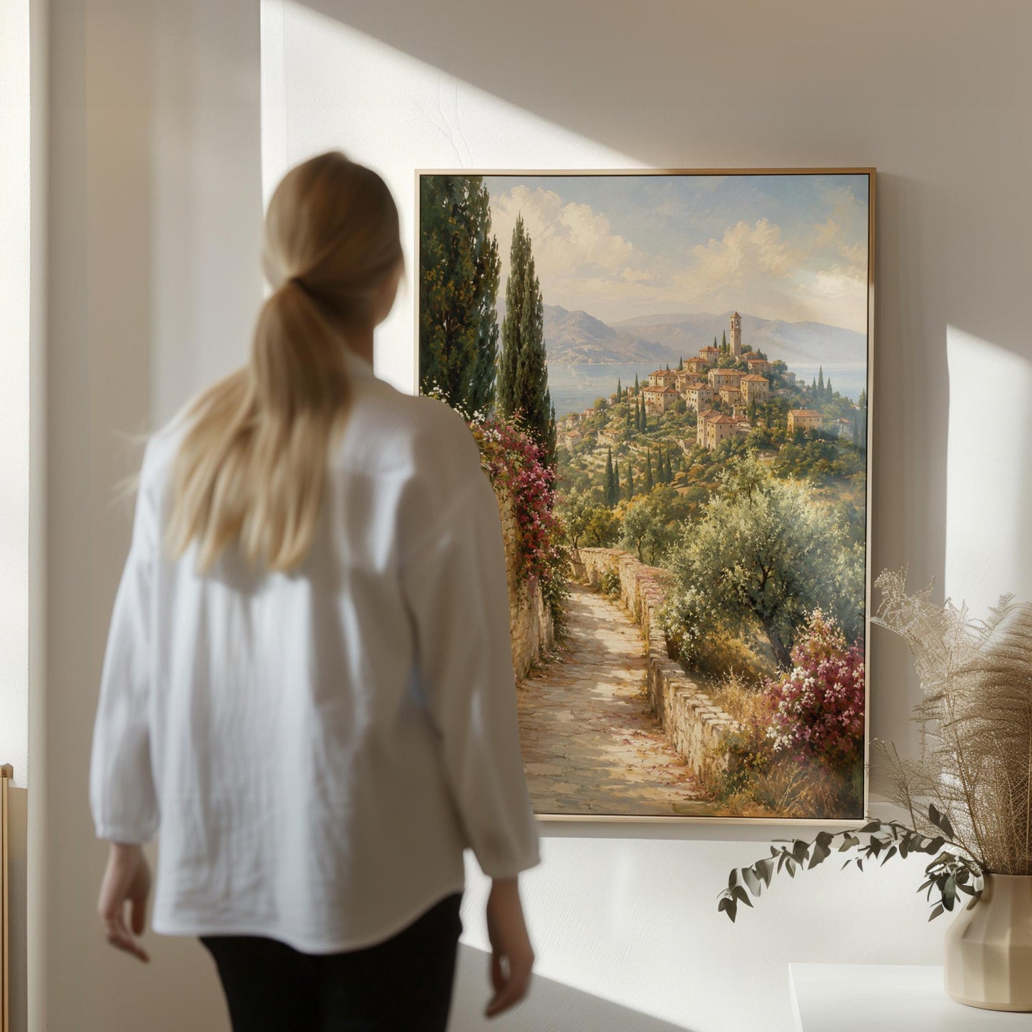Stone path leading to an Italian hilltop village, canvas print shown in a sunlit, contemporary room