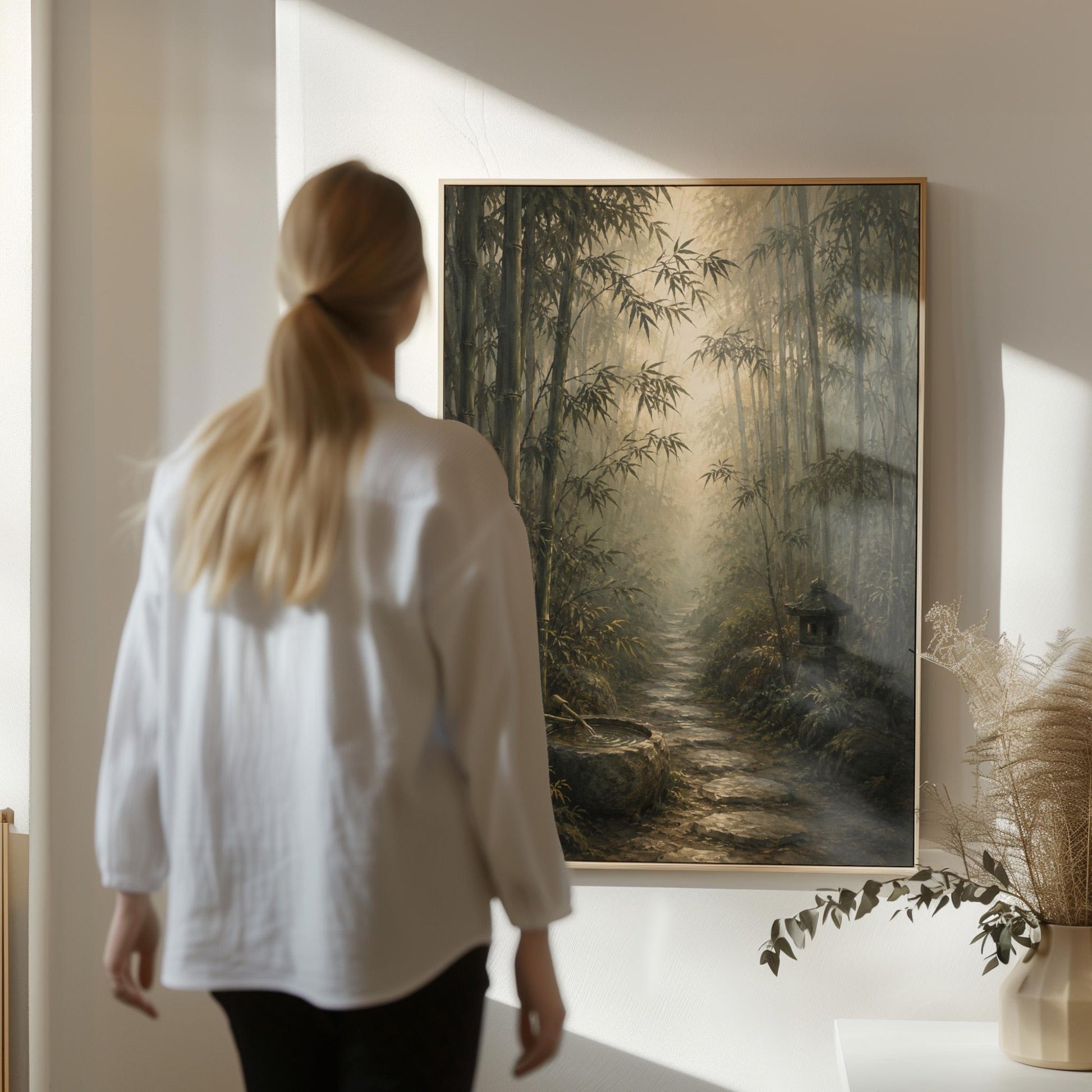 Stone path through a misty bamboo forest with a water basin, canvas wall art presented in a light, minimal room
