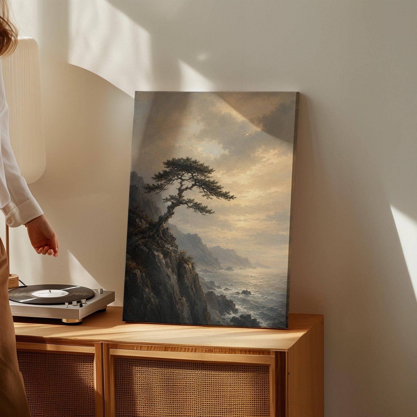 Lone pine on a sea cliff above a restless ocean, canvas print presented in a light, minimal room