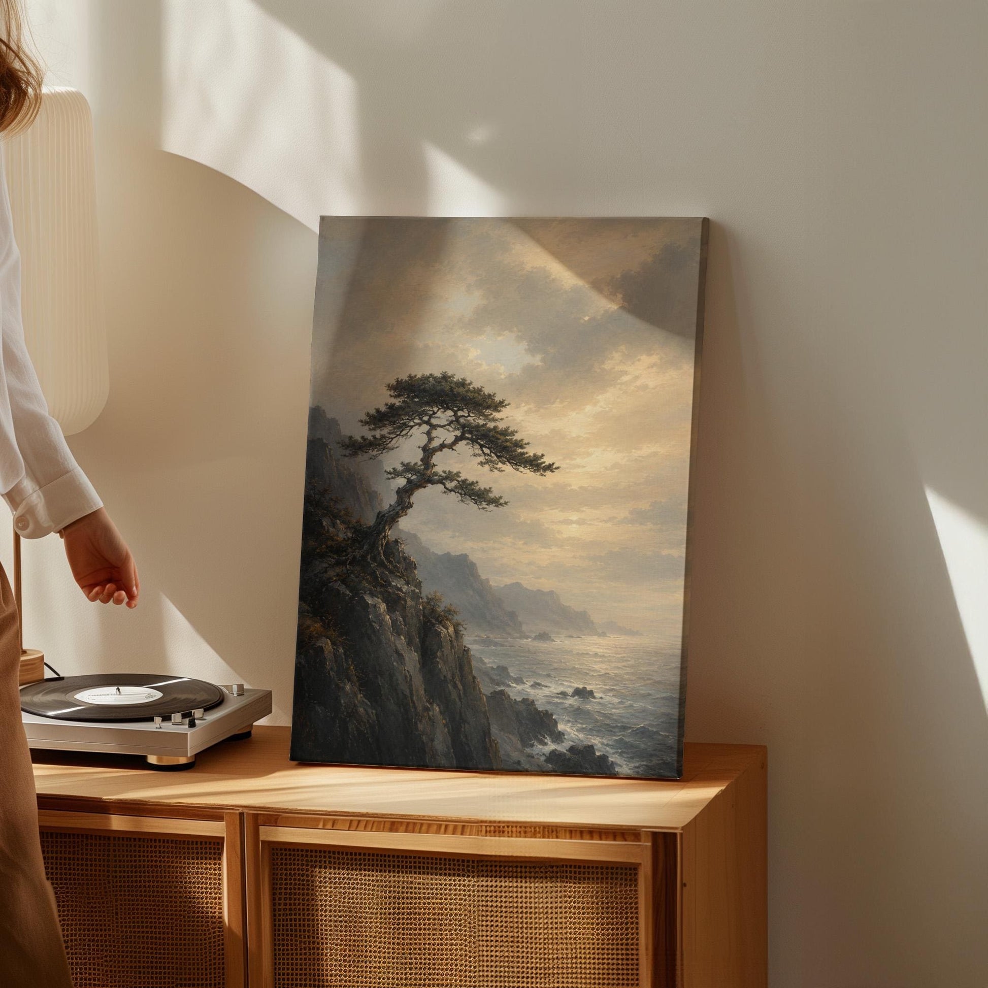 Lone pine on a sea cliff above a restless ocean, canvas print presented in a light, minimal room