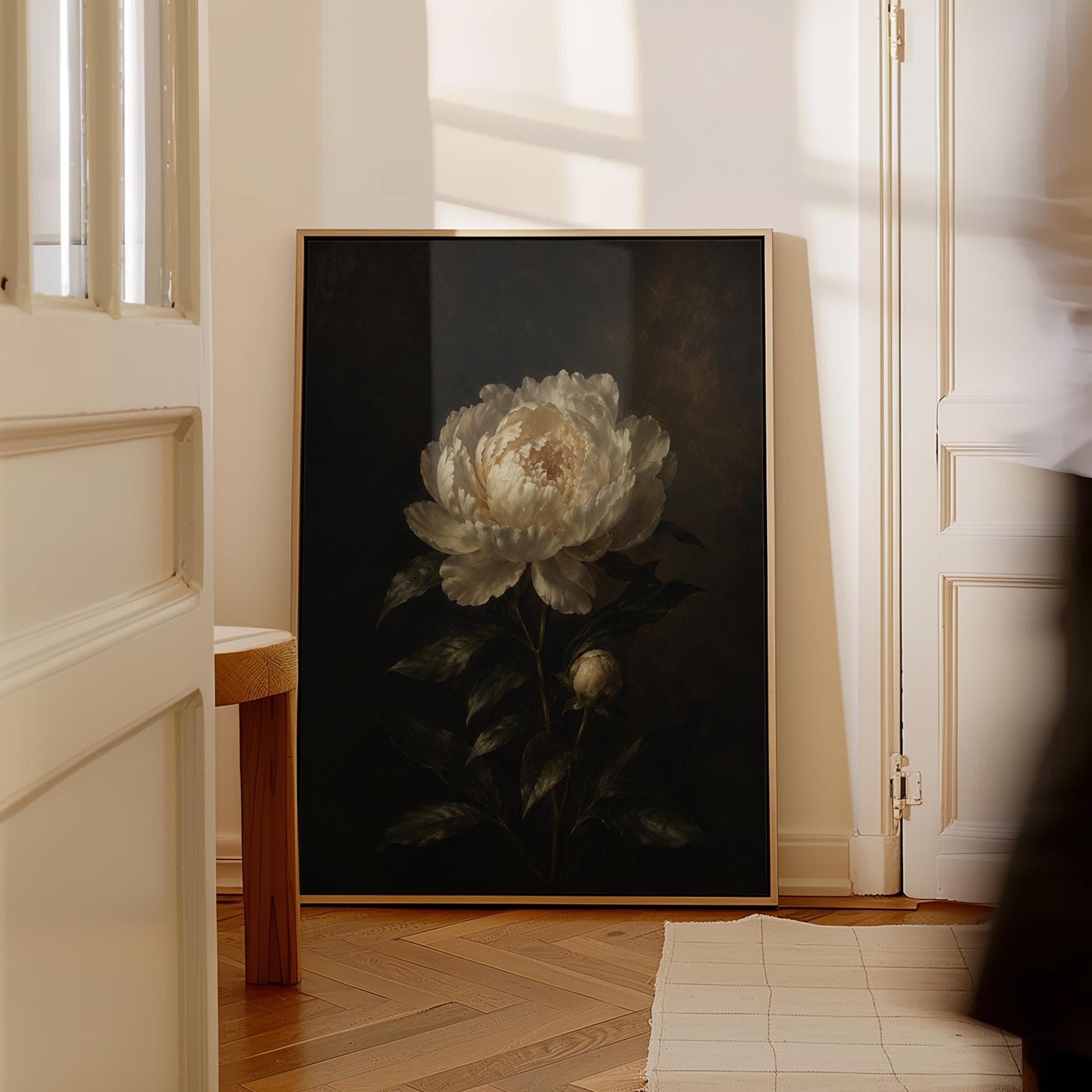 White peony in full bloom against a dark background, canvas print displayed on a neutral wall in a styled interior