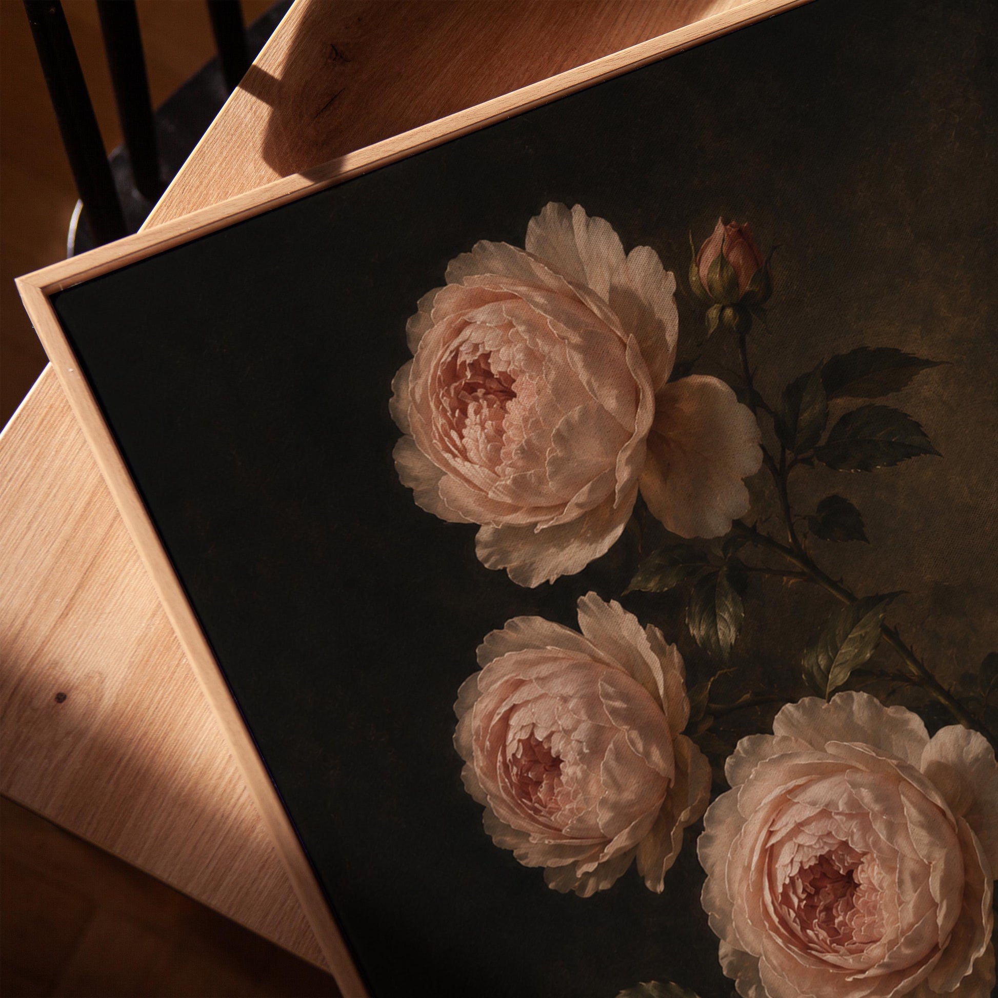 Blush pink garden roses against a dark background, canvas print in a warm, minimally styled interior
