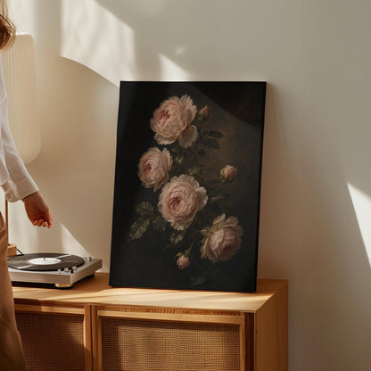 Blush pink garden roses against a dark background, canvas print styled against a soft white wall