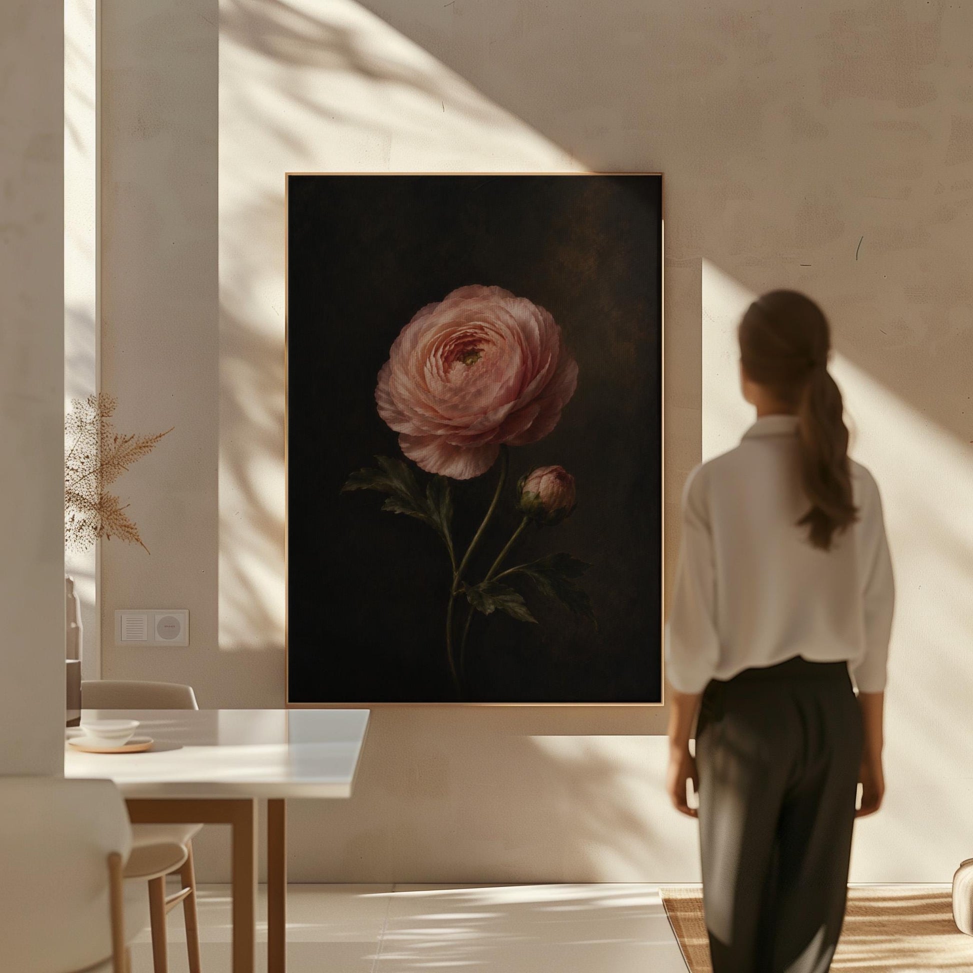 Single pink ranunculus bloom against dark shadow, canvas wall art hanging in a calm, modern living space
