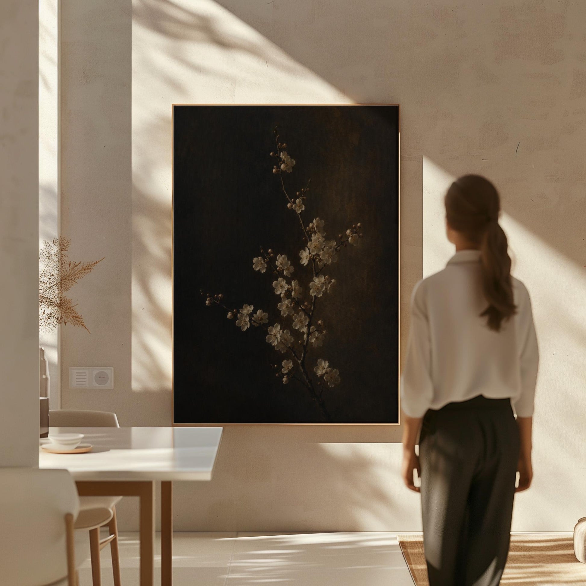 White blossom branch on a dark bronze ground, canvas print seen in a warm interior with natural light