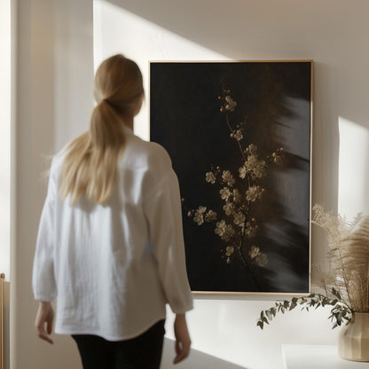 White blossom branch on a dark bronze ground, canvas print presented in a light, minimal room