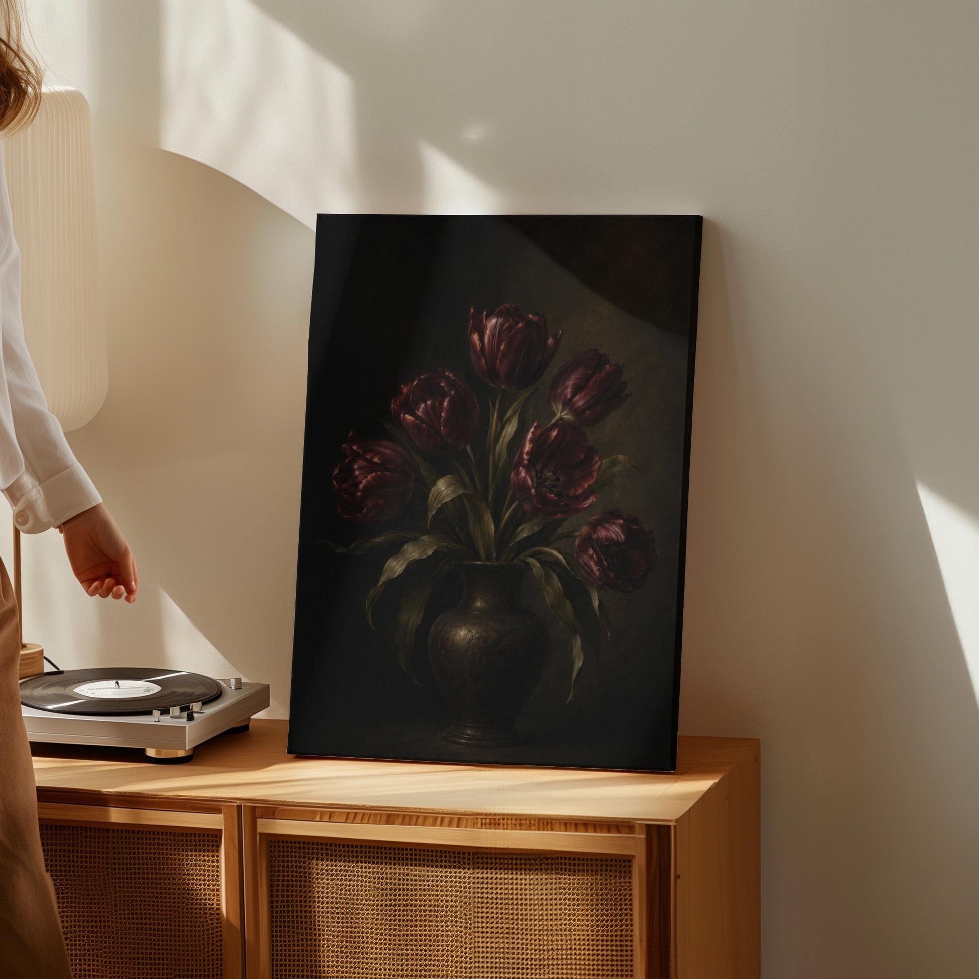 Deep burgundy tulips in a dark metal vase, canvas print shown to scale in a furnished room