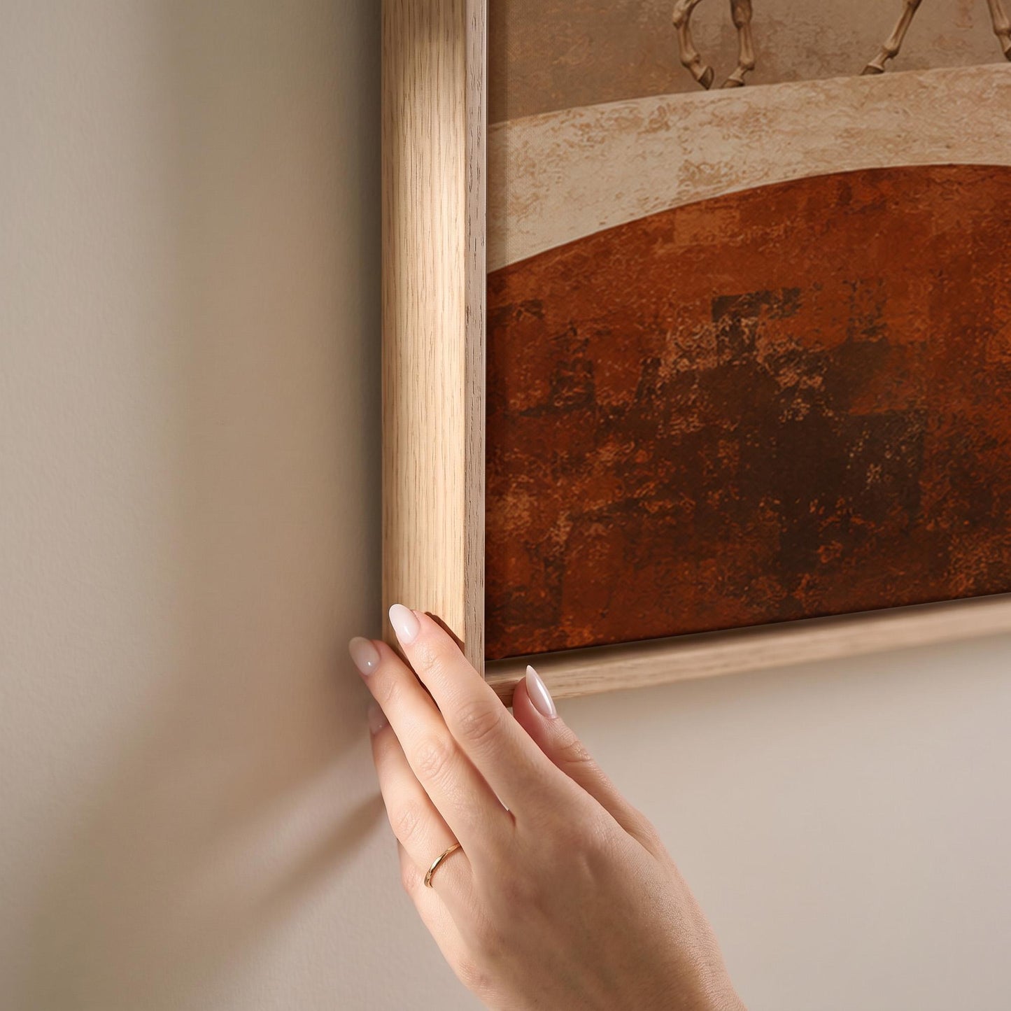 Line of horses crossing an abstract terracotta landscape, canvas print shown at full size in a light-filled bedroom