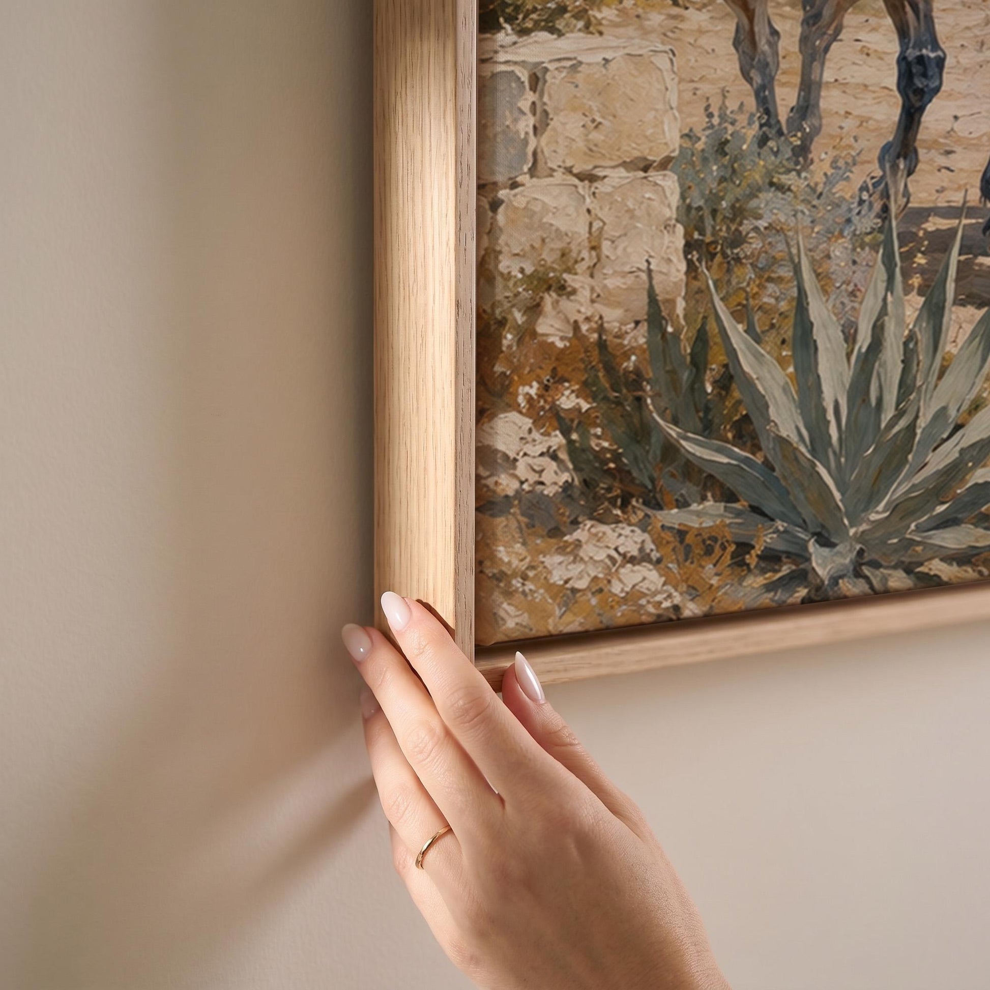 Three horses on a sunlit cliff above a blue Mediterranean bay, canvas print shown at full size in a light-filled bedroom