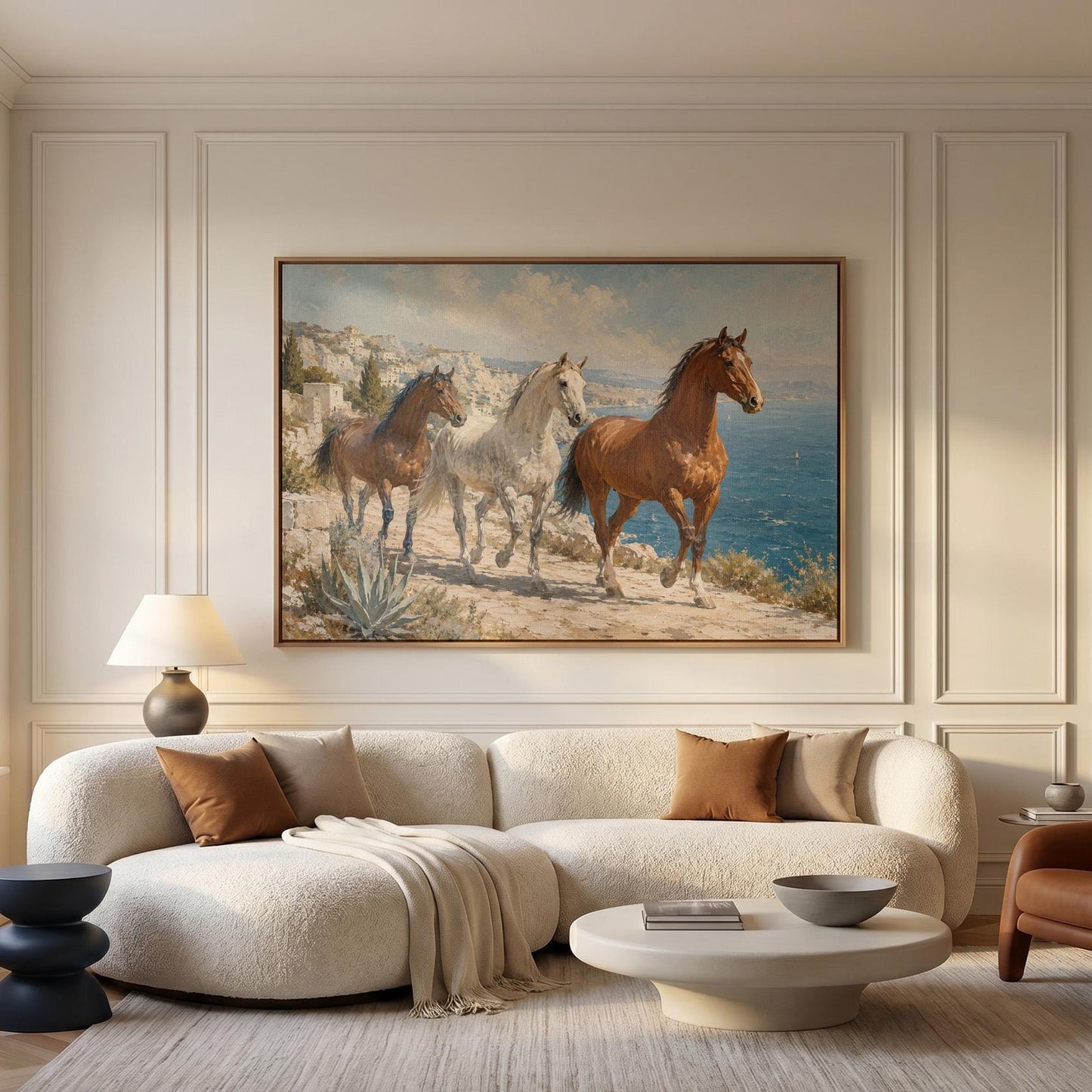 Three horses on a sunlit cliff above a blue Mediterranean bay, canvas print styled against a soft white wall