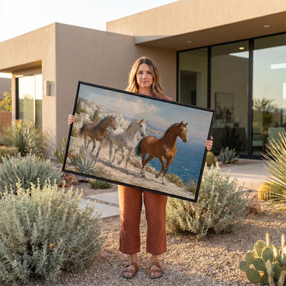 Three horses on a sunlit cliff above a blue Mediterranean bay, canvas print shown to scale in a furnished room